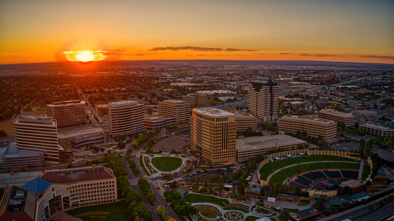 Denver real estate market overview showing the city skyline and financial data representing 2026 inflation hedging strategies.